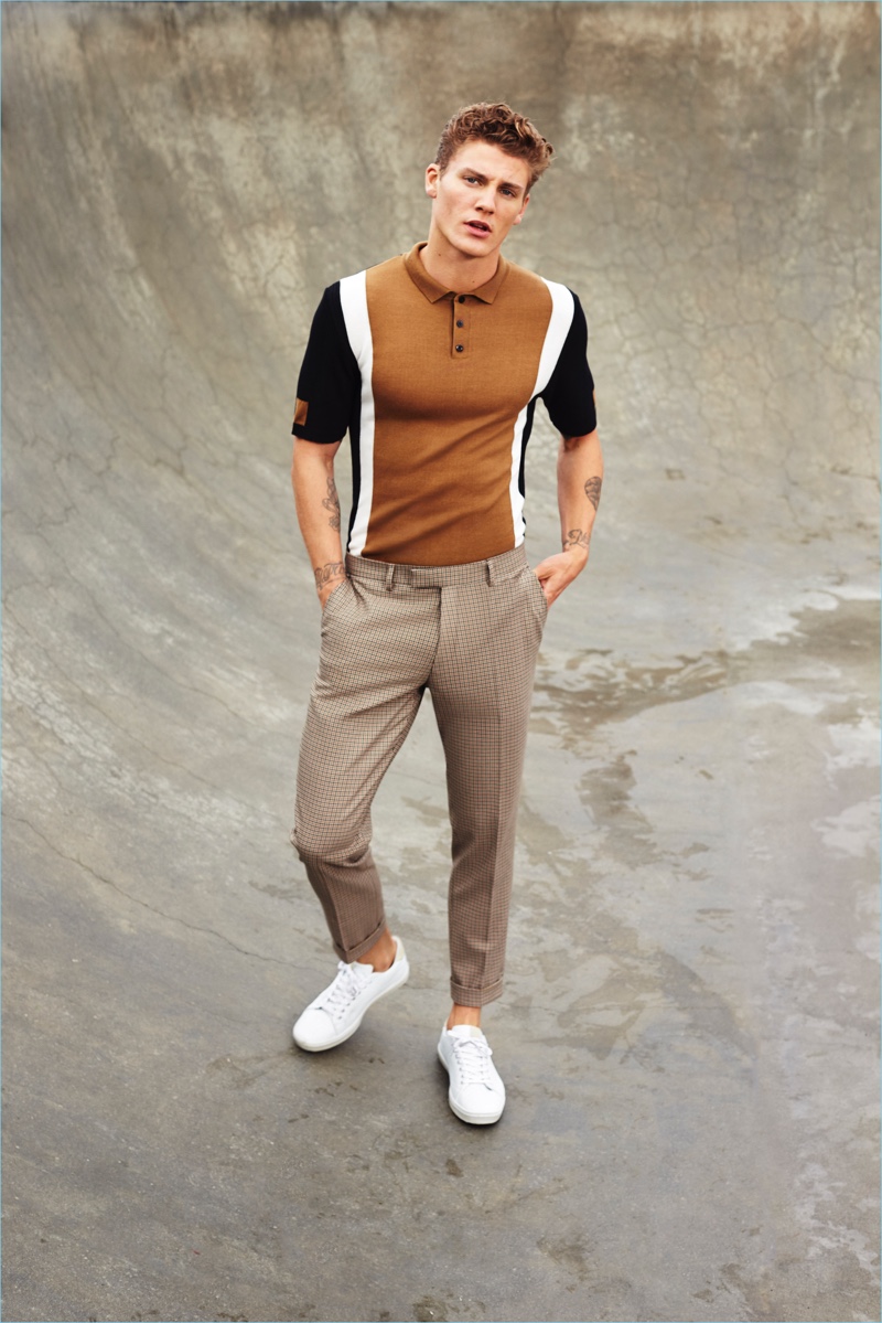 Model Mikkel Jensen dons a color blocked polo shirt and slim trousers with white sneakers for River Island's spring-summer 2017 campaign.