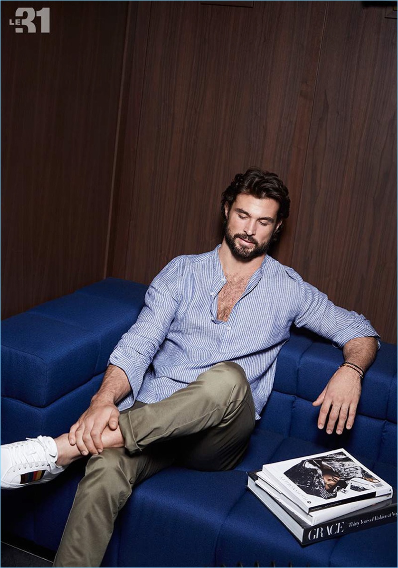 Walter Savage lounges in a striped linen shirt and chinos by LE 31.