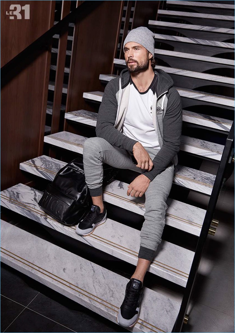 Going sporty, Walter Savage wears a hoodie, joggers, and tee by Reebok.