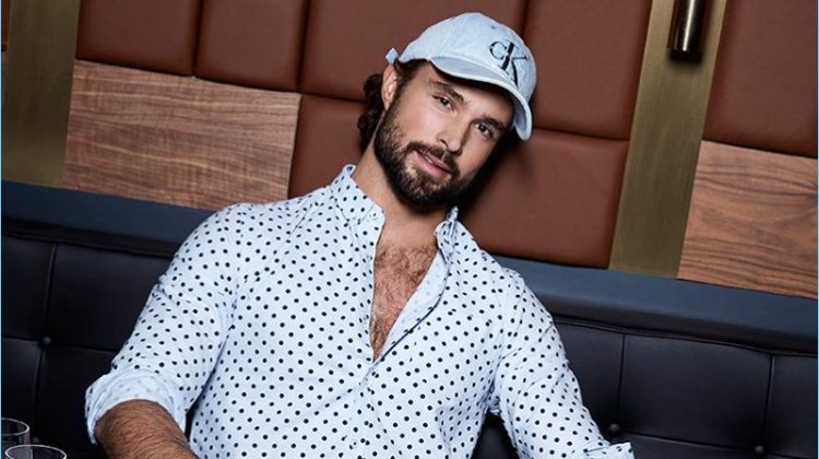 Embracing polka dots, Walter Savage dons a LE 31 oxford shirt with joggers and a Calvin Klein logo cap.