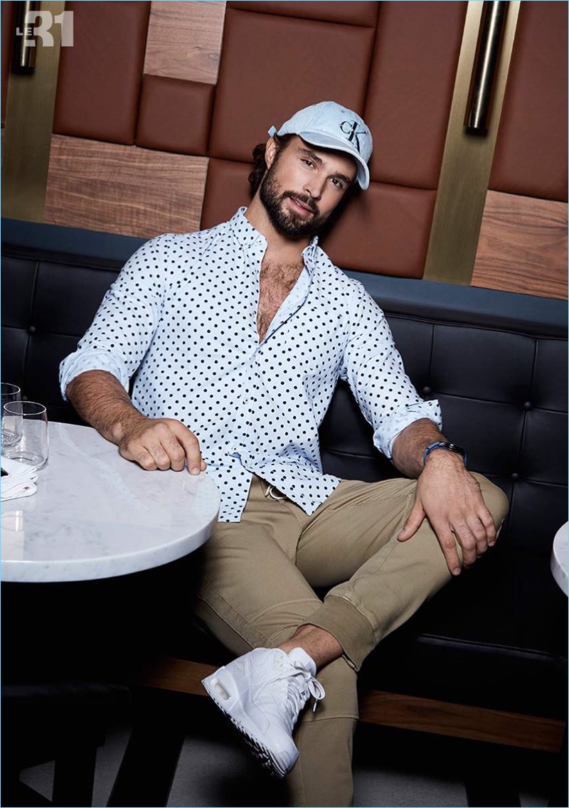 Embracing polka dots, Walter Savage dons a LE 31 oxford shirt with joggers and a Calvin Klein logo cap.