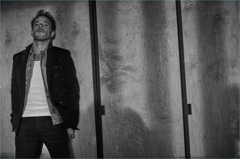 Mark Holmes outfits Stephen Dorff in a Dior Homme jacket, AG denim jacket, Calvin Klein tank, and Saint Laurent jeans.