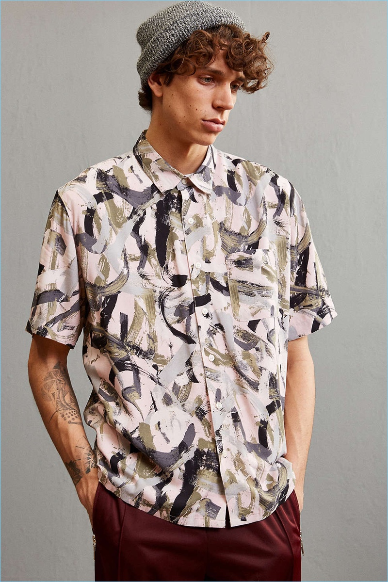 Breezy rayon button-down shirt from Urban Outfitters in an artistic brushstroke print. Lightweight rayon is cut in a standard fit short sleeve silhouette with a pointed collar, full-length front button closure and a flat split hem. Finished with a patch pocket at the chest.