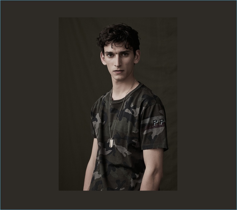 Thibaud Charon wears a camouflage print t-shirt from Valentino's spring 2017 collection.