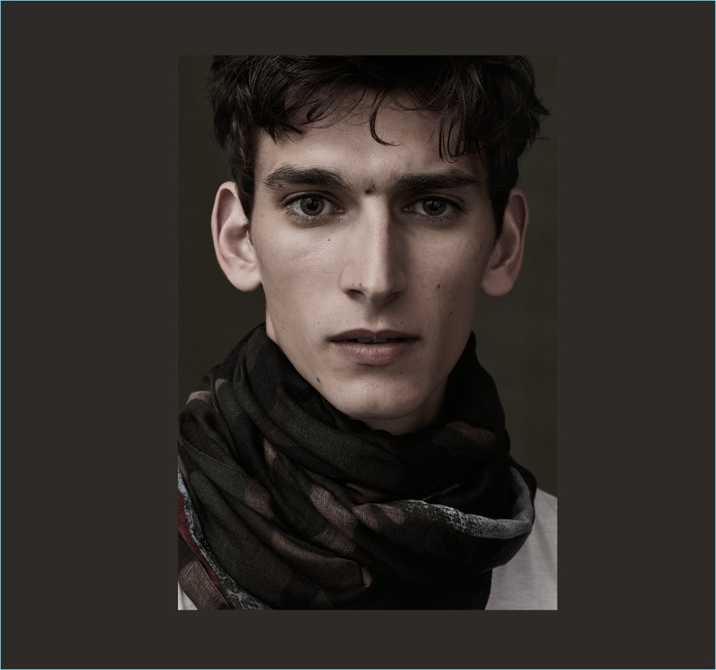 Model Thibaud Charon wears a camouflage print scarf from Italian fashion house, Valentino.