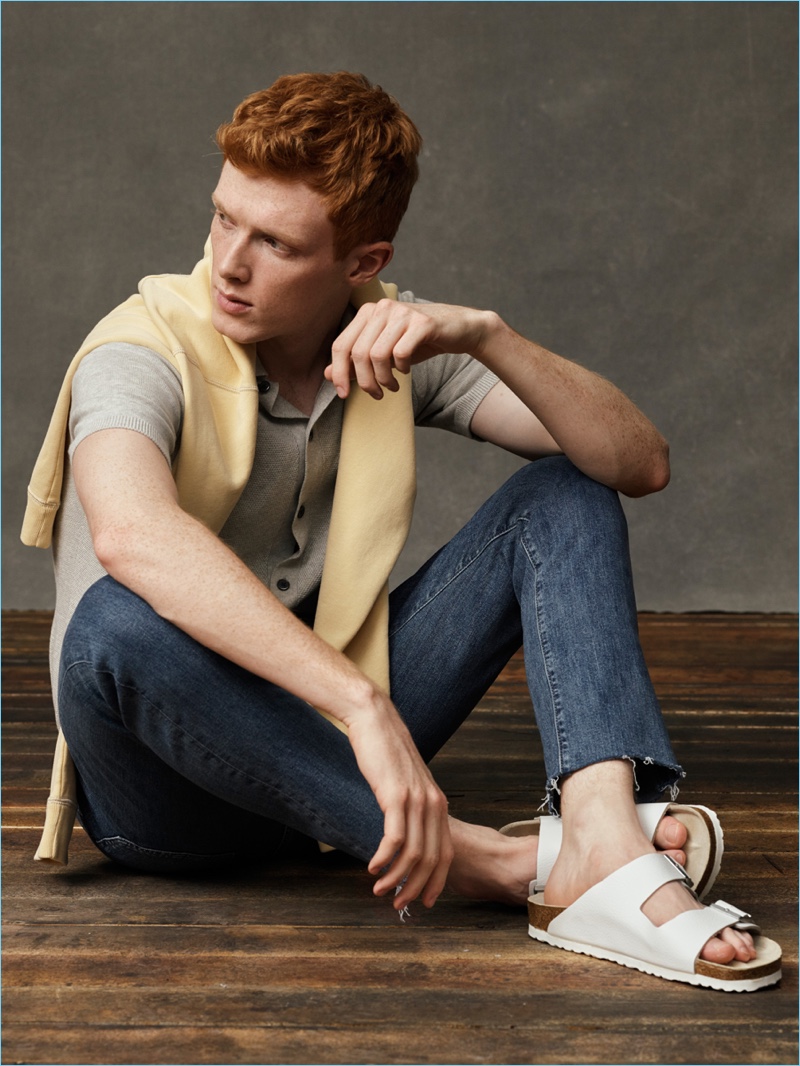 Tapping into ivy league style, Linus Wordemann sports a polo, sweater, and denim jeans by Abercrombie & Fitch.