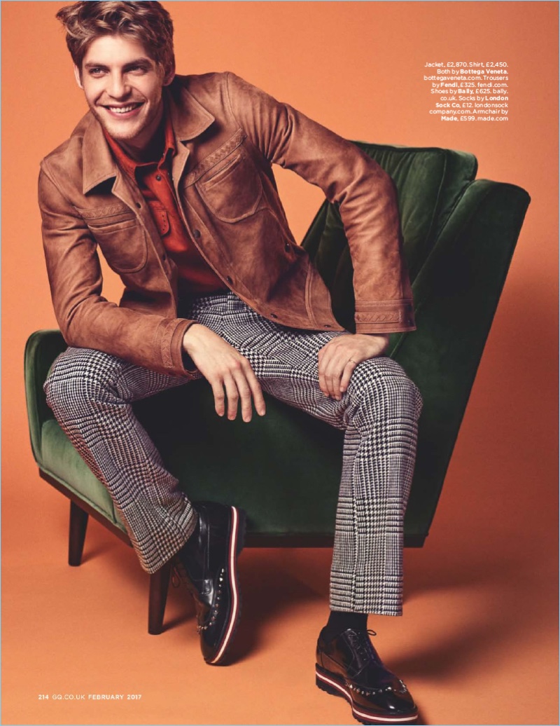 All smiles, Baptiste Radufe wears a leather jacket and button-down shirt by Bottega Veneta. Baptiste also sports houndtooth Fendi trousers and Bally leather shoes.