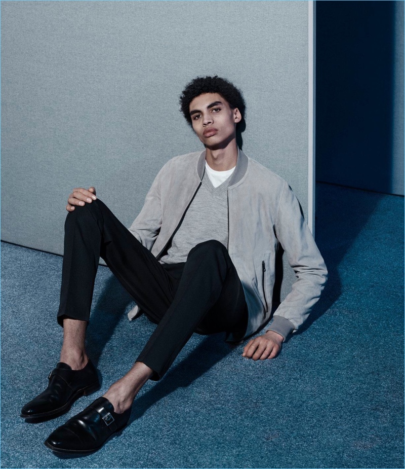 Playing it casual, Sol Goss wears a Lot 78 x Barneys New York suede bomber jacket, Maison Margiela sweater, Valentino trousers, and Crockett & Jones dress shoes.