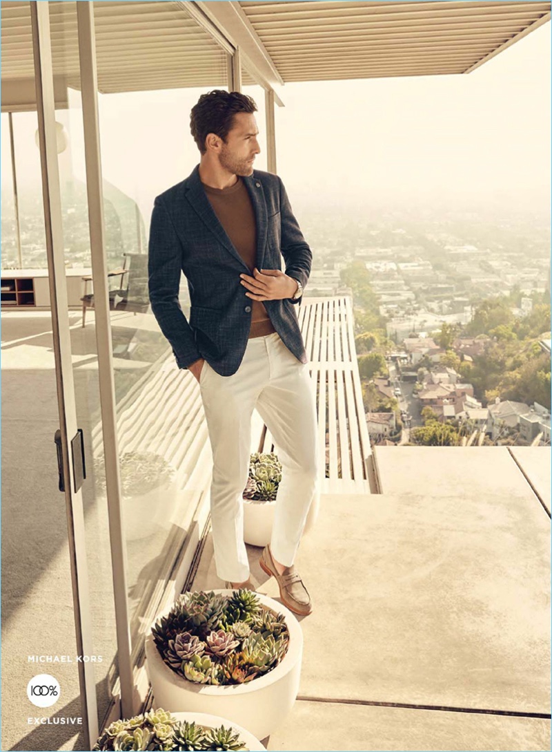 A smart vision, Noah Mills dons tailored essentials from Michael Kors.