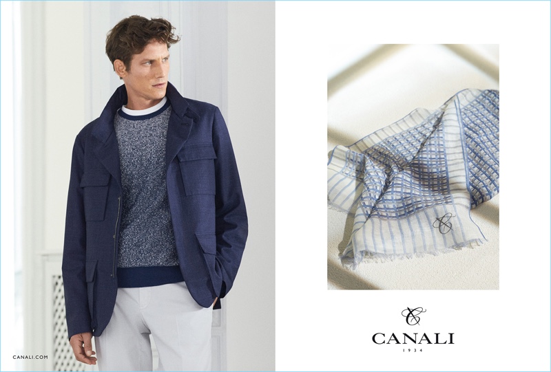 Model Roch Barbot wears a relaxed field jacket over a marble effect sweater and pleated trousers for Canali's spring-summer 2017 campaign.