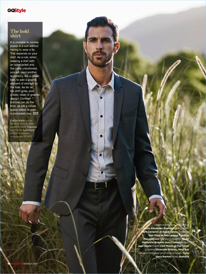 Taking to a picturesque field, Clint Mauro wears a Calvin Klein shirt and suit with a Topman belt.
