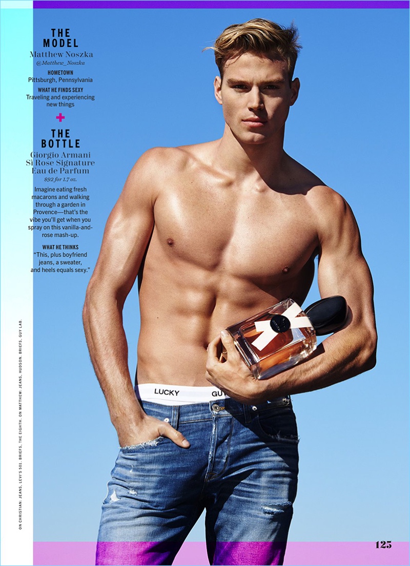 Matthew Noszka shows off his six-pack as he poses with a bottle of Giorgio Armani Si Rose Signature.