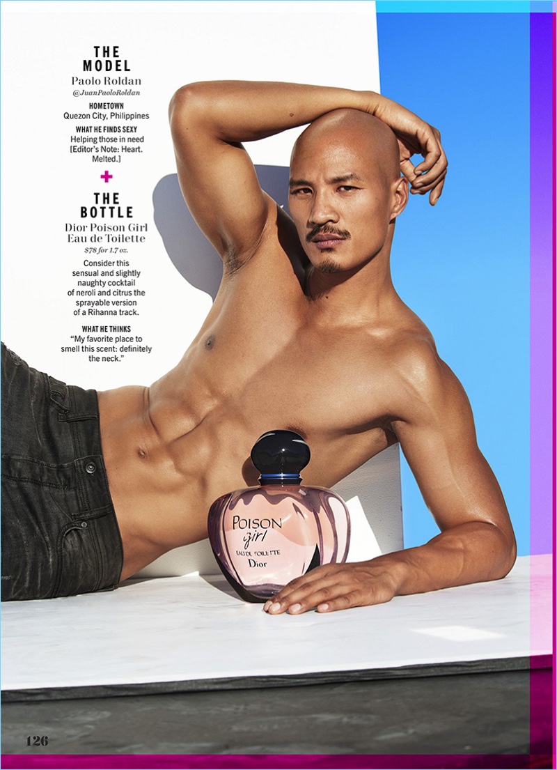 Laying with a bottle of Dior Poison Girl, Paolo Roldan flexes his biceps.