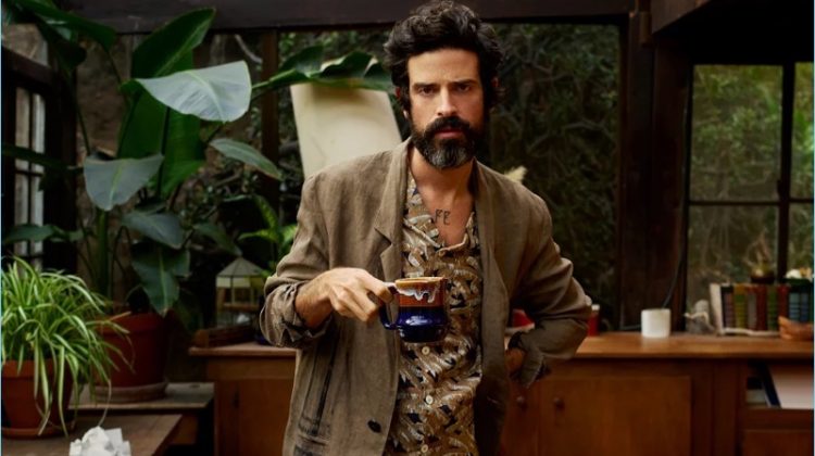 Embracing the style of an artist, Devendra Banhart sports a Valentino camp-collar shirt with trousers and a painted linen overcoat by Isabel Benenato.