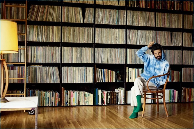 Appearing in a Mr Porter photo shoot, Devendra Banhart rocks a Beams tie-dye hoodie, By Walid trousers, and The Workers Club socks.
