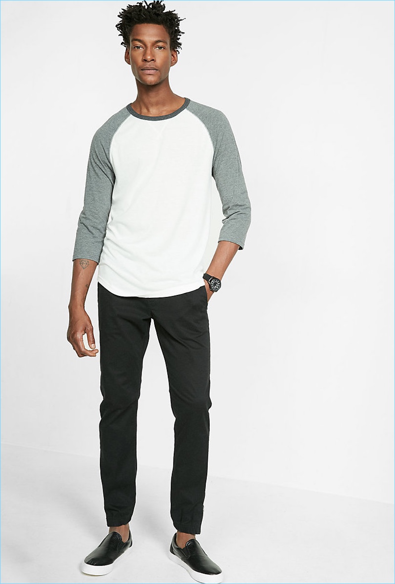 Ty Ogunkoya embraces easy everyday style with Express' baseball tee and slim-fit black pants.