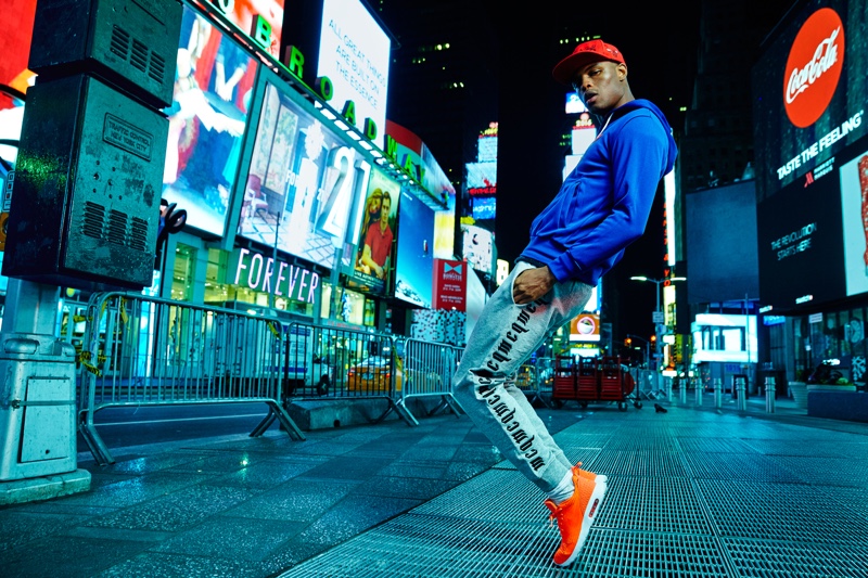 Isaiah wears hoodie Comme des Garçons, pants Alexander McQueen, hat stylist's own, and shoes Nike.