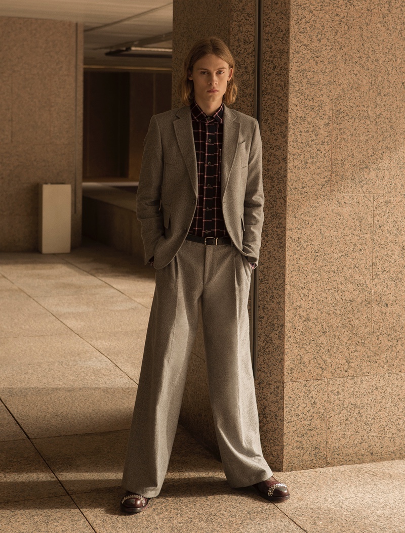 Samuel wears shirt Nine in the Morning, suit Garcia Madrid, and shoes Loewe.