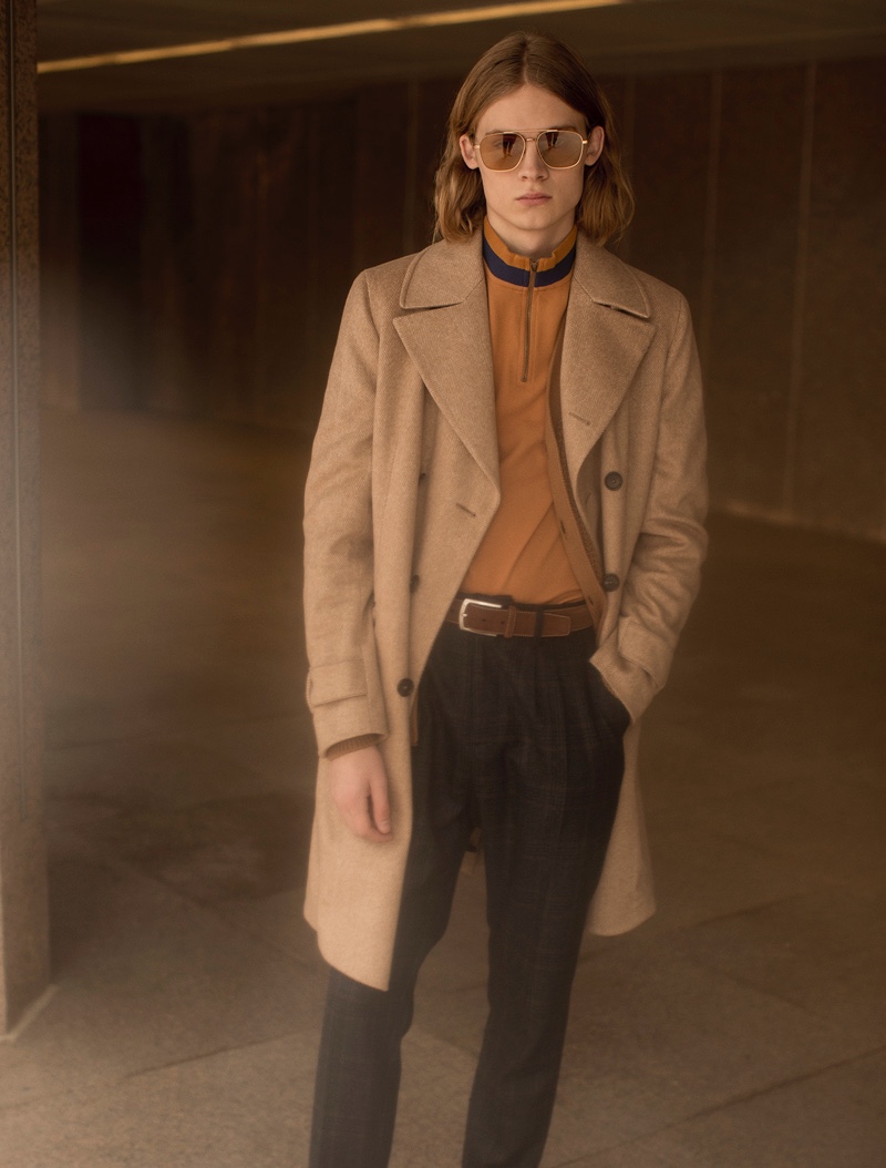 Samuel wears coat Z Zegna, t-shirt Fred Perry, trousers Antony Morato, belt Forecast, and sunglasses Givenchy for Safilo.