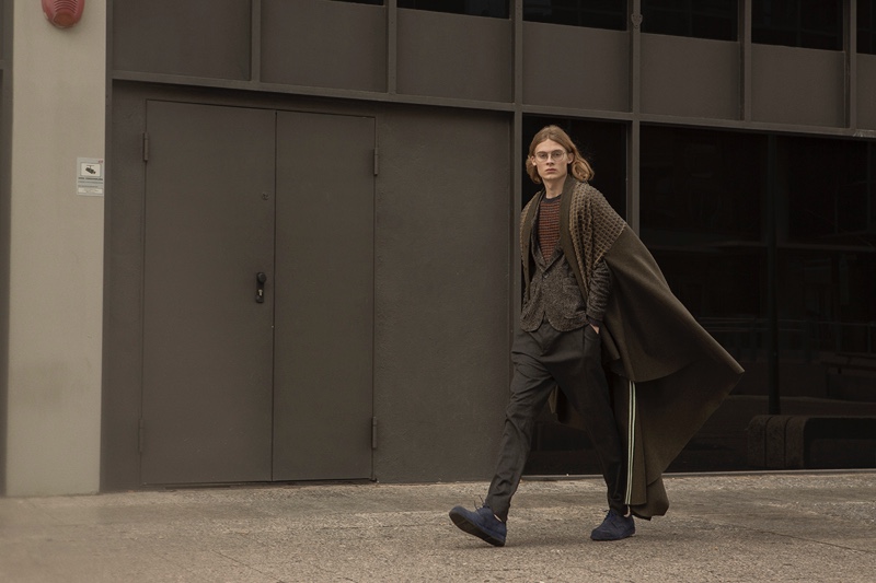 Samuel wears cape Ana Locking, trousers Antony Morato, glasses Dior for Safilo, shoes Camper, blazer and pullover Soloio.