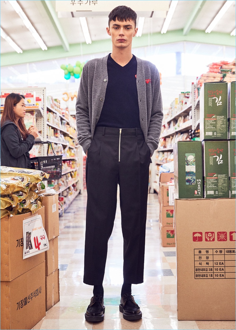 Model Simon Kotyk wears a double emblem cardigan and v-neck sweater by Comme des Garçons Play. Simon also sports 3.1 Phillip Lim suiting trousers and Comme des Garçons Homme Plus dress shoes.
