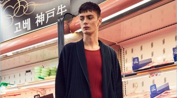 The Eastern Edit: Simon Kotyk Models Forward's Must-Haves Embracing a draped silhouette, Simon Kotyk dons an Issey Miyake Homme Plisse long jacket with a red shirt and pleated cropped trousers. Simon's look is complete with Acne Studios leather sneakers.