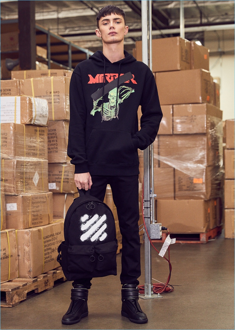 Simon Kotyk gets into Off-White with a mirror skull hoodie and graphic backpack. Simon also wears Givenchy jeans and Maison Margiela sneakers.