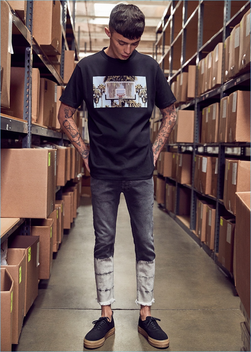 Going casual, Simon Kotyk wears a Palm Angels graphic t-shirt with EYTYS sneakers.