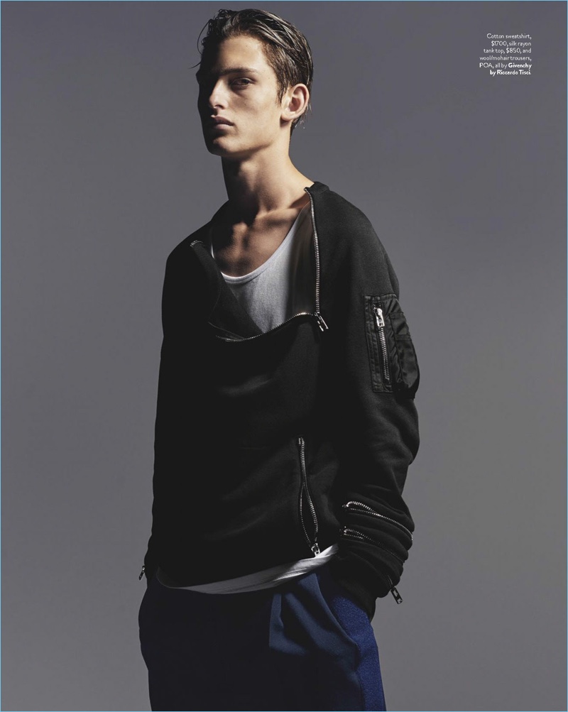 Edward Mulvihill photographs James Manley in a sweatshirt, tank, and trousers by Givenchy.