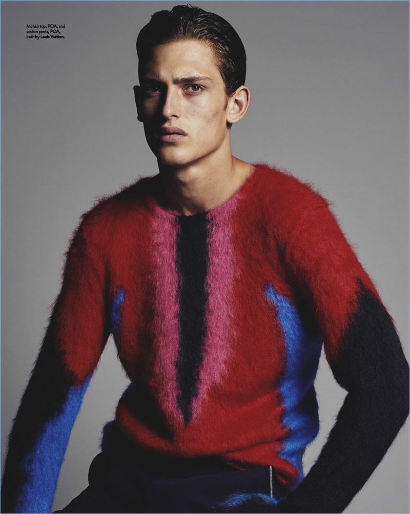 James Manley wears a graphic sweater and trousers by Louis Vuitton.