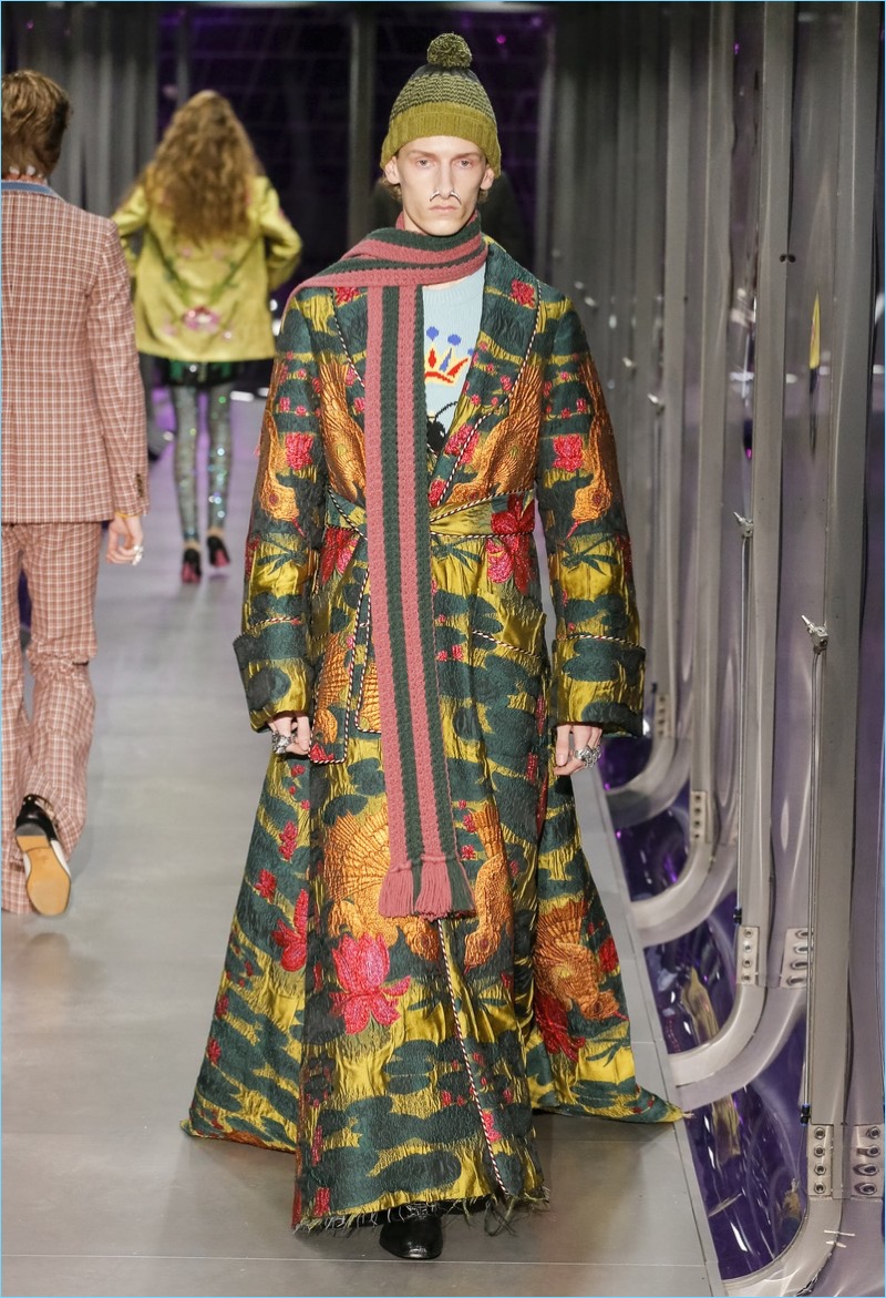Designer Alessandro Michele makes quite the statement with a graphic coat for Gucci's fall-winter 2017 men's collection.