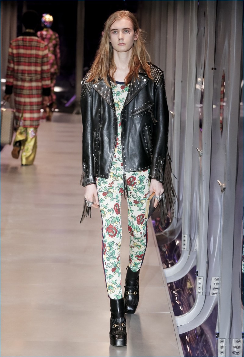 Floral prints collide with a rocker edge as Gucci turns out a studded leather biker jacket.