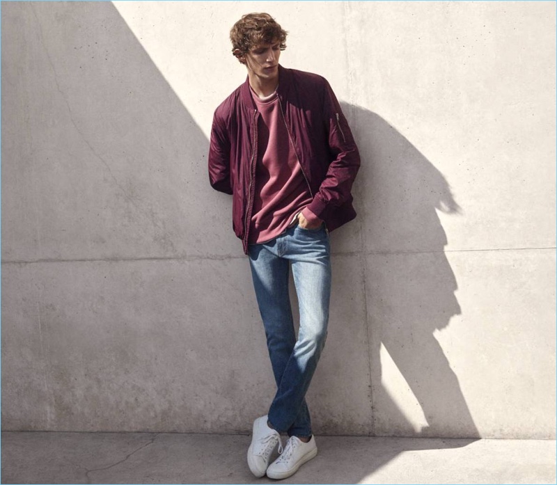 H&M enlists model Xavier Buestel for its denim lookbook, which features a casual bomber jacket, scuba-look sweatshirt, t-shirt, slim regular jeans, and white sneakers.