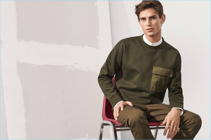 Tapping into H&M's military style trend, Arthur Gosse wears a scuba-look sweatshirt with a slim fit shirt and twill pants.