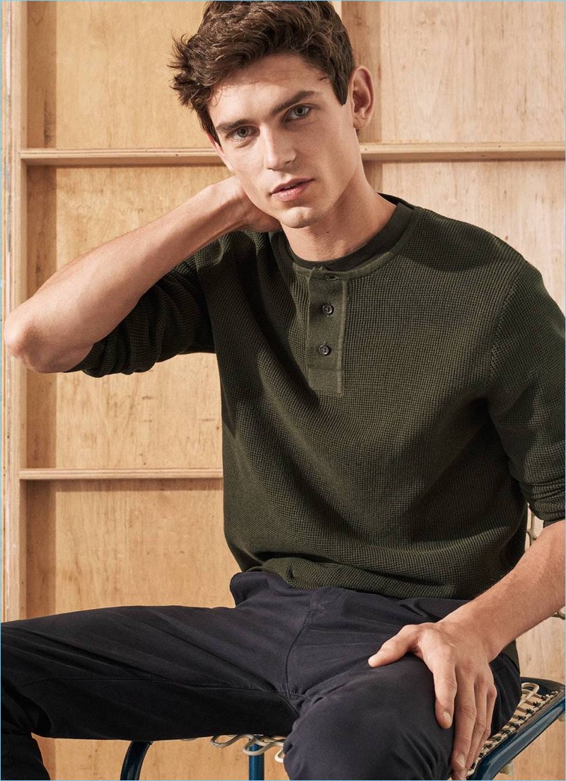 French model Arthur Gosse goes casual in a henley with a simple tee and navy chinos from H&M.
