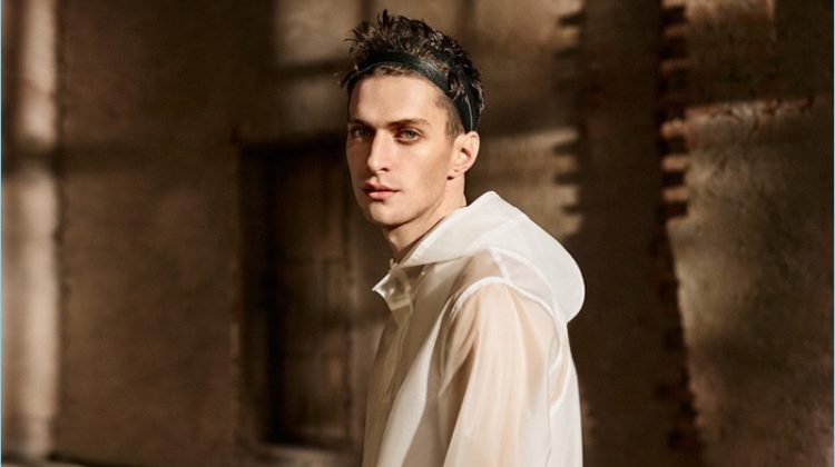 Making quite the style statement, Matthew Bell wears a white raincoat and shorts from H&M Studio.
