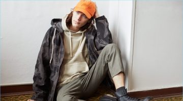 Jaco van den Hoven Embraces Street Style for Reserved Spring '17 Outing Model Jaco van den Hoven layers in a hoodie, camouflage print jacket, and twill pants with combat boots.