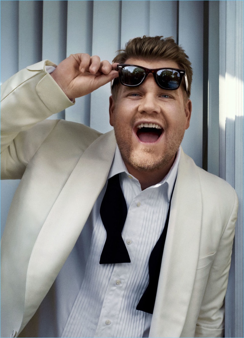 Appearing in a photo shoot for Esquire, James Corden wears a formal look by Ralph Lauren with Ray-Ban sunglasses.