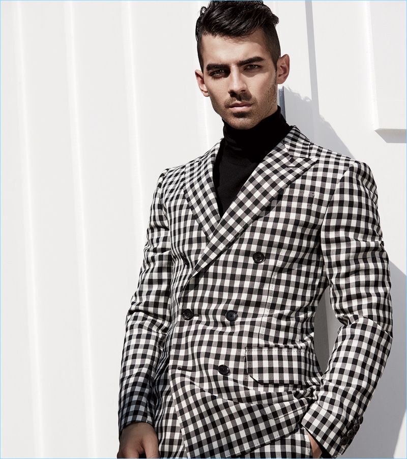 DNCE frontman Joe Jonas sports a black and white check suit with a turtleneck by Bally.