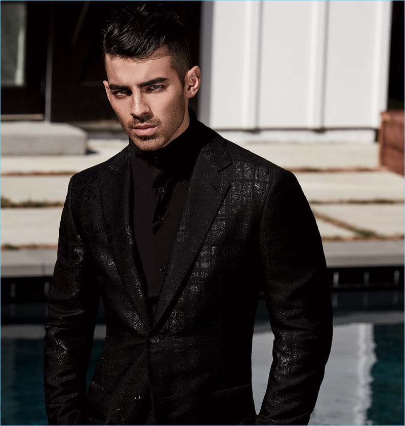 Striking in a photo, Joe Jonas wears a shirt, jacket, and trousers by Hermes.