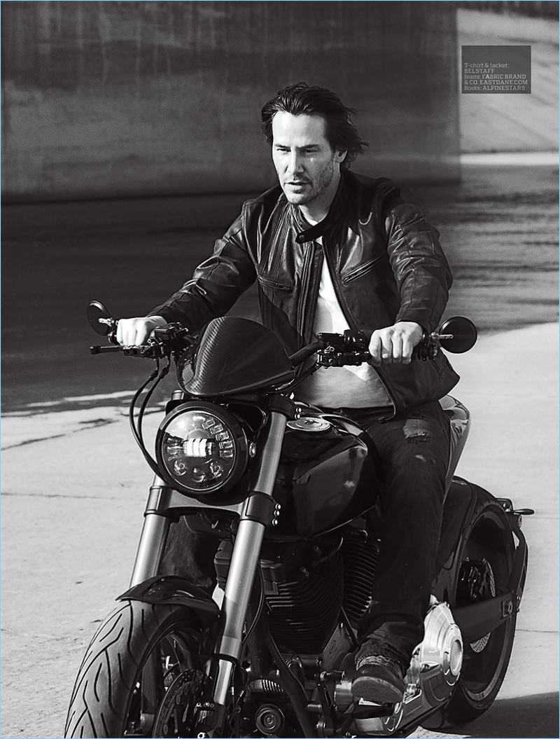 Riding a motorcycle, Keanu Reeves rocks a t-shirt and leather jacket by Belstaff.
