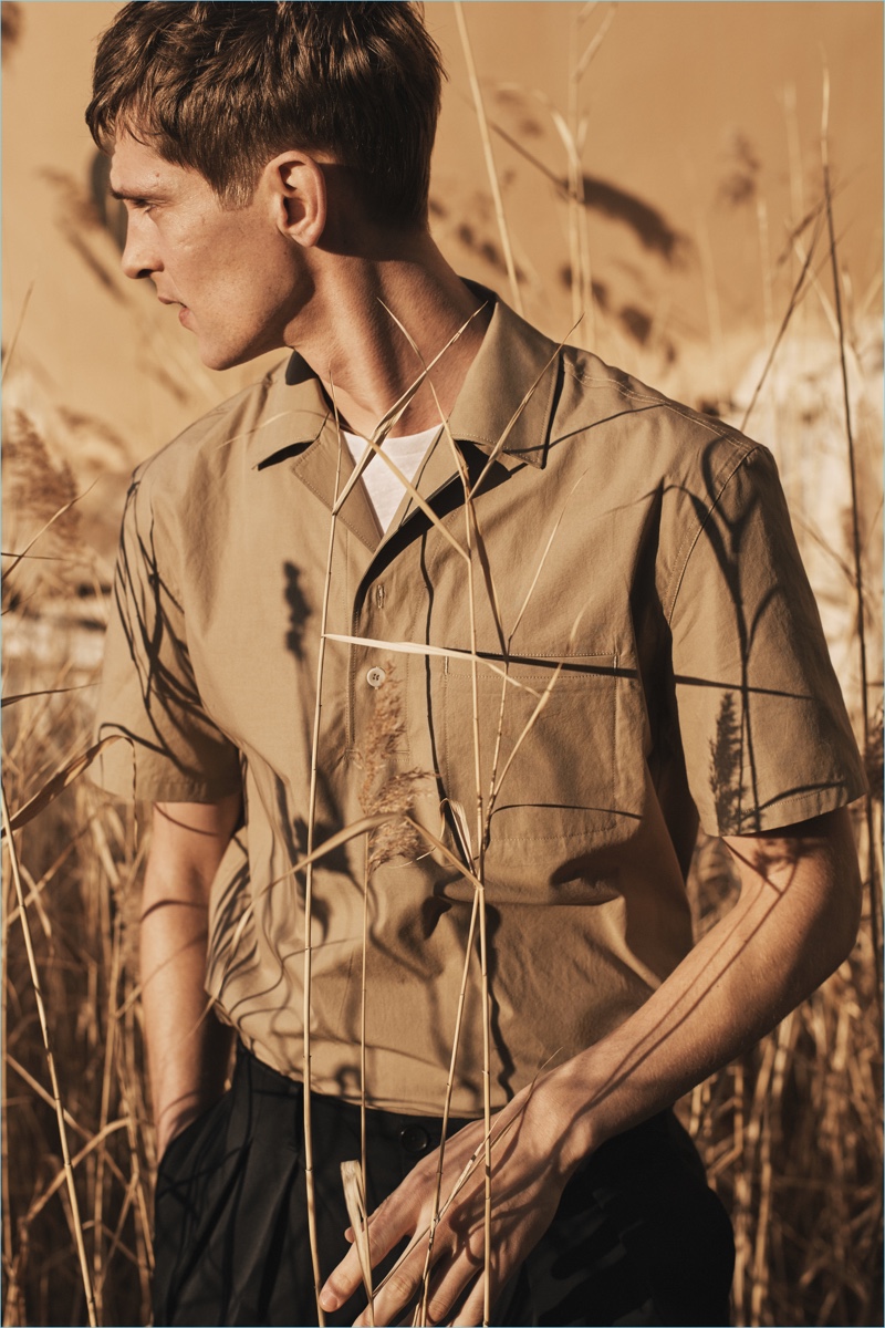 Venturing outdoors, Mathias Lauridsen dons a Cuban collared shirt from Mango Man's Committed Collection.