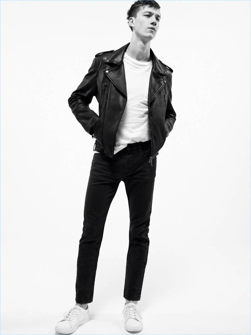 Playing it cool, Harvey James sports black denim jeans with a white tee and leather biker jacket by Mango Man.