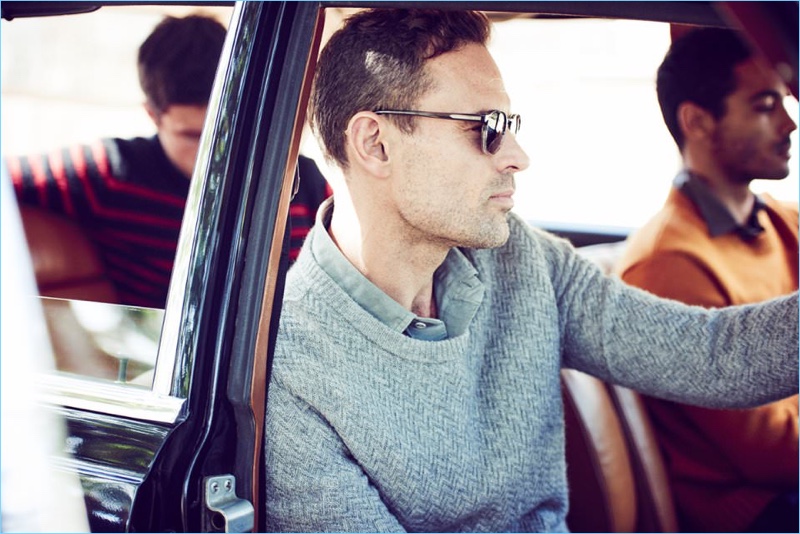 Left to Right: Charlie Timms wears a striped sweater by The Elder Statesman. Cornelius wears a sweater and shirt by Ralph Lauren Purple Label with Moscot sunglasses. Alex Cruz wears an Ami sweater and Barena shirt.