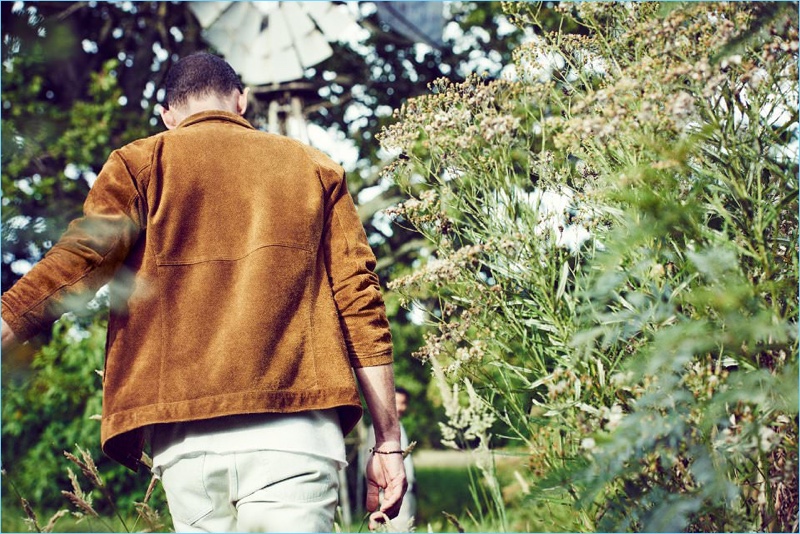 Cornelius wears a suede Nonnative jacket with a t-shirt by The Elder Statesman and A.P.C. denim jeans.