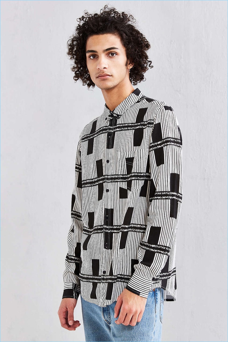 Model Tre Samuels sports Neuw's black lines rayon button-down shirt from Urban Outfitters.