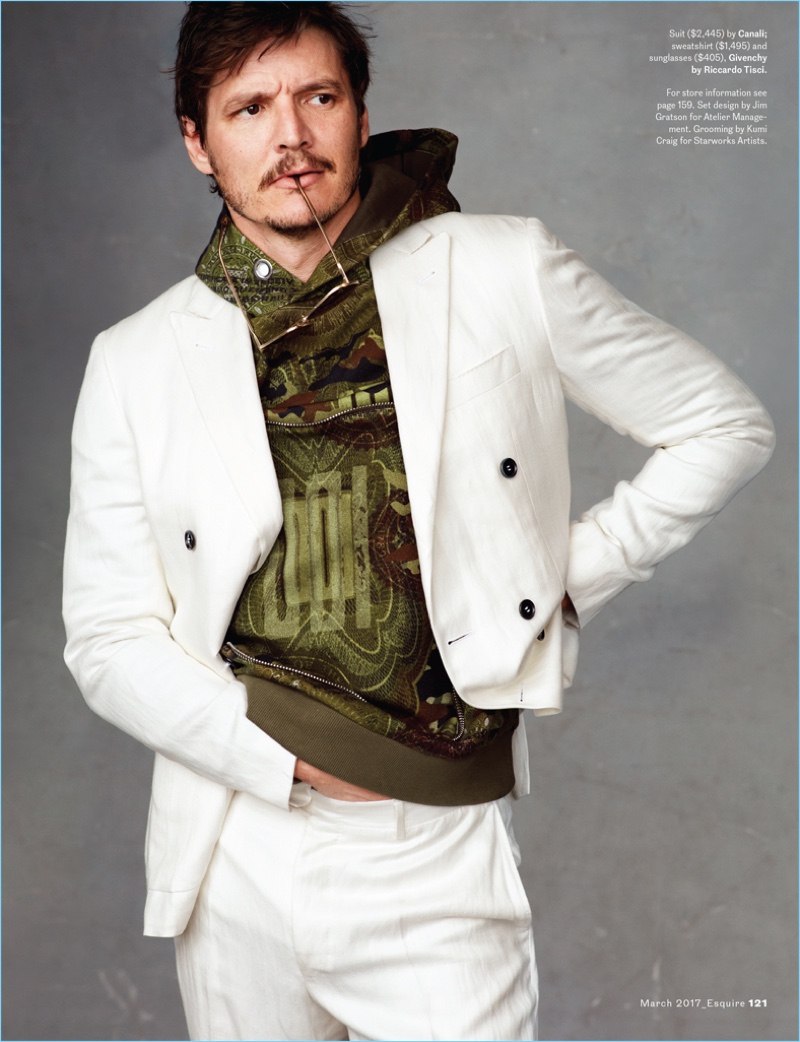 Narcos actor Pedro Pascal sports a Canali suit with a sweatshirt and sunglasses by Givenchy.