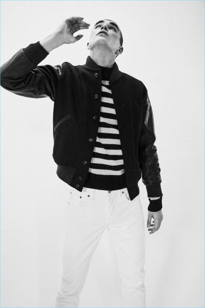 Diego Villarreal sports a leather sleeve bomber jacket, striped sweater, and jeans from RRL.