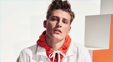 River Island Tackles Sporty Ease for High Summer '17 Collection A colorful vision, Mikkel Jensen wears an orange hoodie with a white denim jacket and swim shorts by River Island.