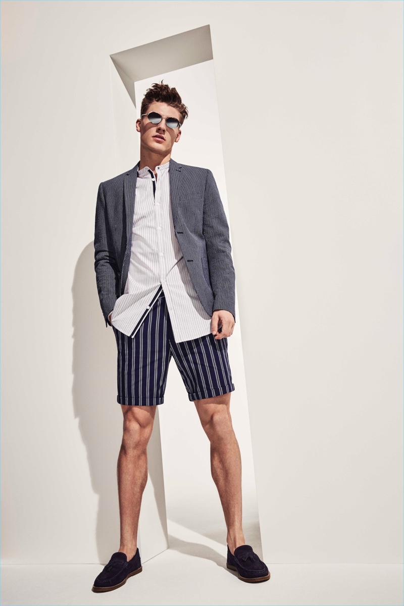Bringing smart style to the forefront, Mikkel Jensen dons a sport coat with a striped shirt and shorts.